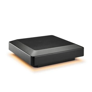 A compact, rectangular black electronic device is shown against a white background. The device features a subtle orange glow emanating from its base, suggesting it is powered on or in use. The minimalist design and clean lines give it a modern, high-tech appearance. No visible text, numbers, or logos are present on the device.