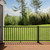 Trex Select Aluminum Railing in Charcoal Black installed on deck with green yard view.