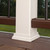 Trex Classic White post skirt installed on 6x6 composite post sleeve on brown composite deck with railing.