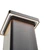 A sleek, contemporary bollard light is shown from a low angle, emphasizing its illuminated top edge. The fixture features a minimalist design with a rectangular column and integrated LED lighting around the upper perimeter. The setting appears to be outdoors, with the focus on the architectural and lighting details. The color palette is neutral, dominated by metallic and soft white tones.