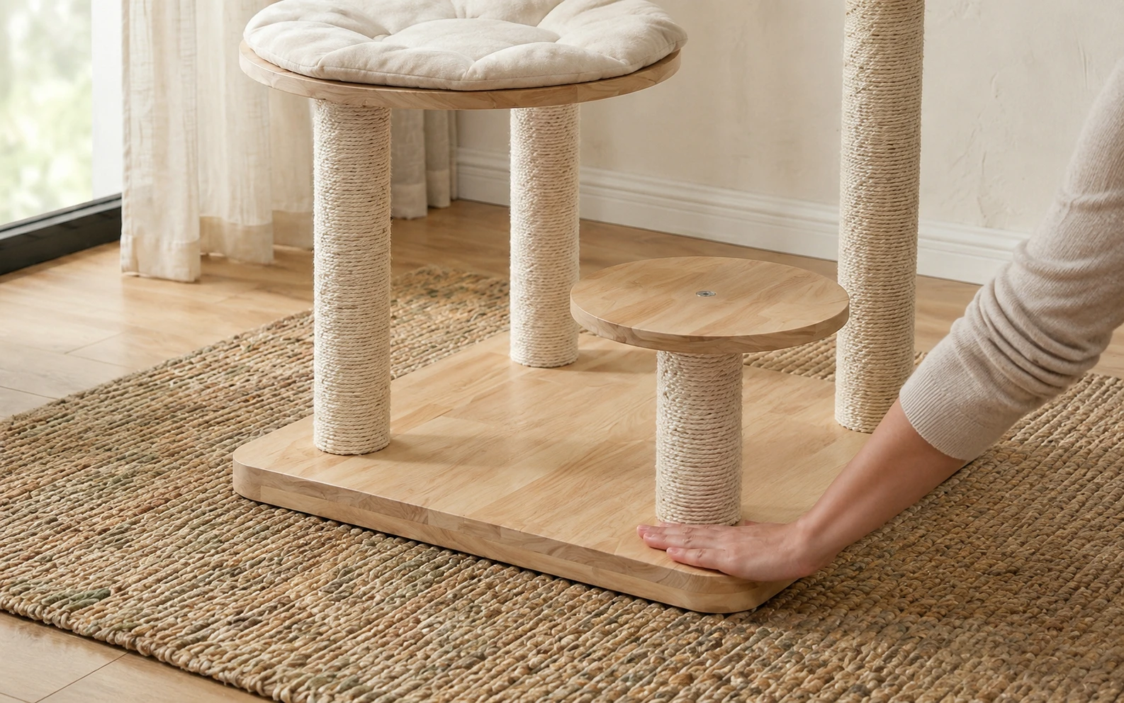 Hand pressing on the wide base of a cat tower to test stability