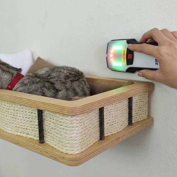 Close-up of a premium wall shelf bracket and wooden edge installed on a white wall