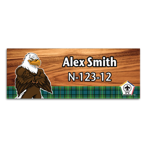 Wood Badge Name Tag with Wood Badge Tough Eagle Critter on strip of Tartan design with Wood Badge Logo Wood Badge Name Tag with Wood Badge Tough Eagle Critter on strip of Tartan design with Wood Badge Logo