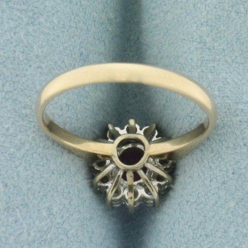 Ruby and Diamond Halo Ring in 14K Yellow Gold