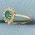 Emerald and Diamond Halo Ring in 14k Yellow Gold