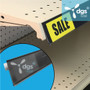 black plastic price tag shelf strip label holder with adhesive back shown on gondola shelf edge in a retail store