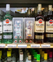 commercial mini 50ml liquor bottle display shown on retail shelving next to larger 750ml bottles