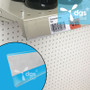 Self-Adhesive Plastic Shelf Strip Tag Holder, Clear 1-1/4H x 36W shown installed on a gondola shelf edge at retail