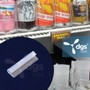 cheap magnetic sign holder for displaying retail for sale signs in stores shown on double wire cooler shelf in a convenience store
