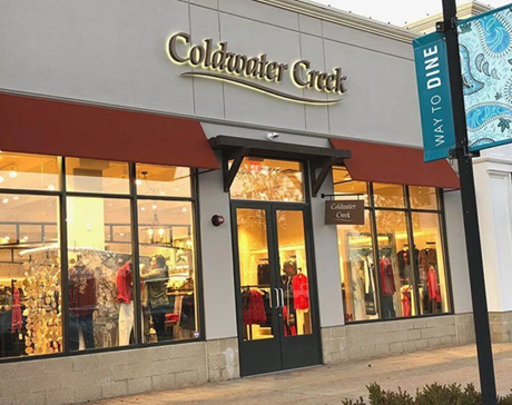 a storefront that uses faux wood accents on the exterior doorway