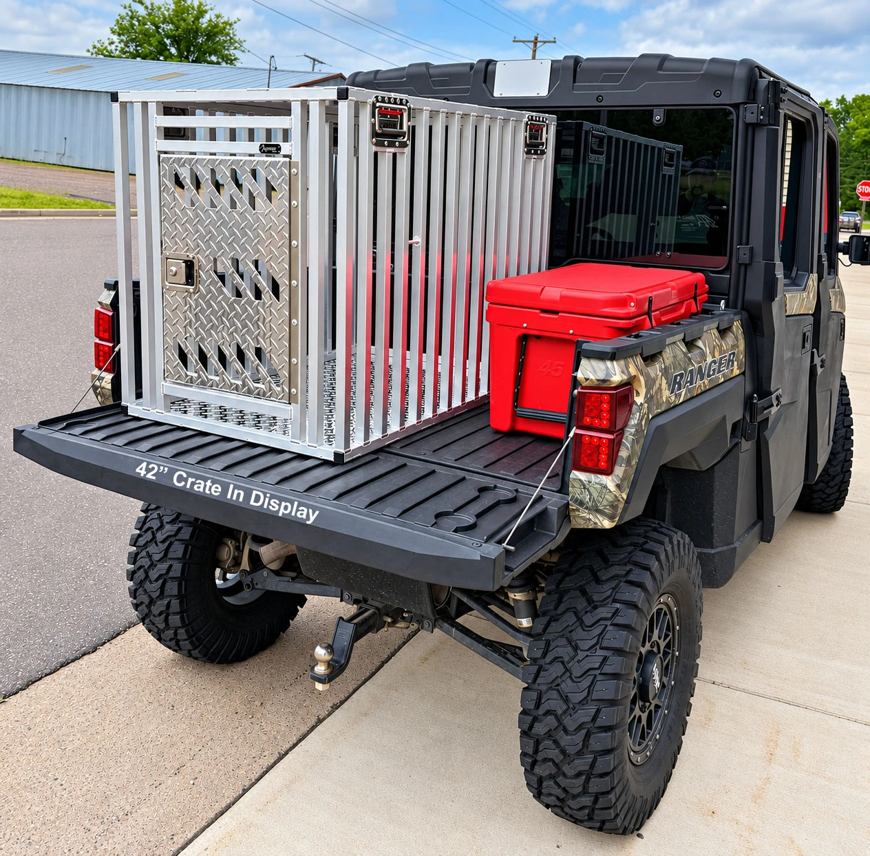Full vent dog crate mounted in UTV cargo bed