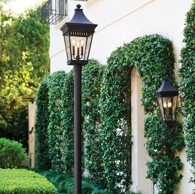 Post lantern lighting pathway near driveway