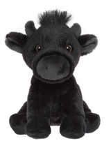 A black plush cow teddy bear with small horns, a grey muzzle, brown eyes, a white patch on its chest, and a tuft of hair on its head, sitting upright against a white background.