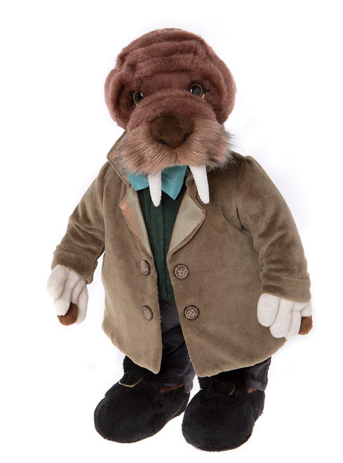 A walrus Charlie Bear stands upright, dressed in a tan double-breasted jacket, green sweater, dark trousers, and black shoes, with white tusks and whiskers, against a white background.