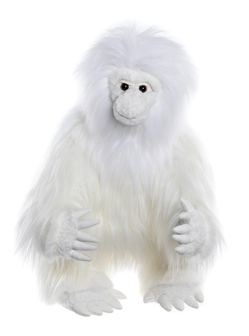 A white fluffy Charlie Bears teddy bear resembling a yeti or primate, with black button eyes, a grey muzzle, and outstretched knitted paws, photographed against a white background.