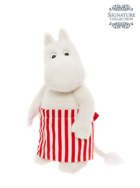 A white Moomin plush toy stands upright, wearing a red and white vertical striped skirt, with a round hippo-like face, small ears, and a fluffy tail.