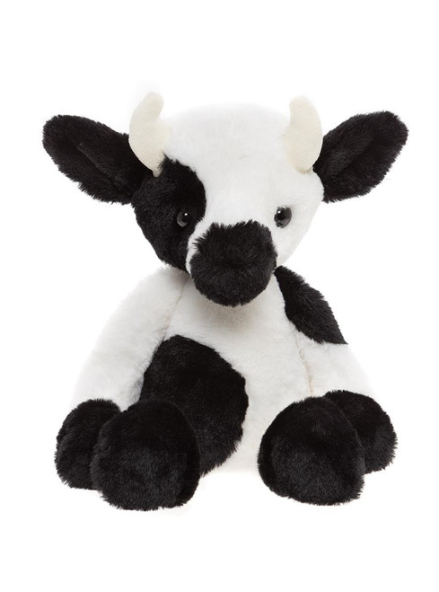 A black and white cow plush toy sits upright against a white background, featuring small cream-coloured horns, rounded ears, and a soft spotted pattern.