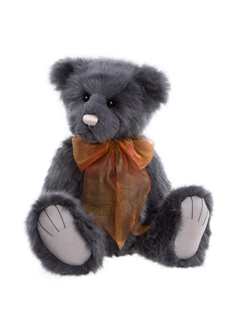 A dark grey plush teddy bear sits upright against a white background, wearing a shimmery copper/orange organza bow tie around its neck.