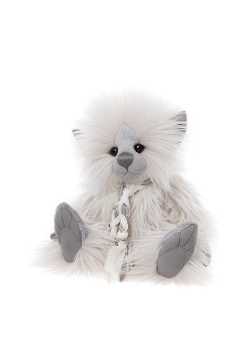 A fluffy white Charlie Bears teddy bear with grey suede paws, nose, and ears sits upright, adorned with a braided white ribbon tie, against a plain white background.