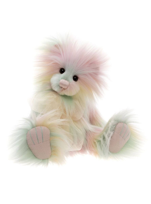 A fluffy, pastel rainbow-coloured Charlie Bear teddy sits upright against a white background, featuring long wispy fur in pink, mint green, and cream tones with suede-effect paw pads.