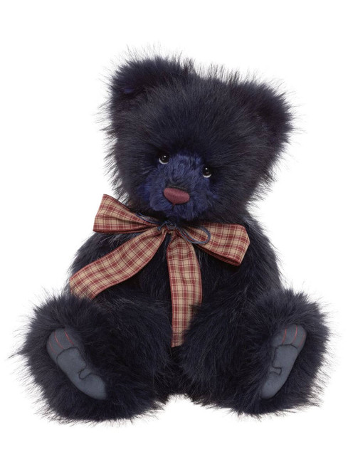 A dark navy/black fluffy teddy bear sits upright against a white background, wearing a red and beige plaid ribbon bow tied around its neck.