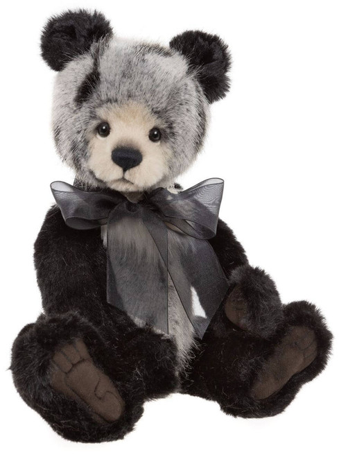 A panda-style Charlie Bear teddy sits upright against a white background, featuring dark brown plush fur, a grey-tipped face, black ears, and a sheer grey organza bow tie.