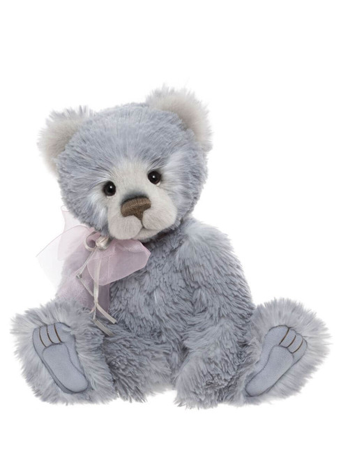 A grey plush Charlie Bears teddy bear sits upright against a white background, wearing a delicate pink organza ribbon bow tied at its neck.