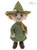 A plush teddy bear dressed in a green outfit and matching wide-brimmed witch-style hat, with orange hair, brown eyes, and a mustard yellow scarf, stands upright against a white background.