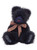 A dark navy/black fluffy teddy bear sits upright against a white background, wearing a red and beige plaid ribbon bow tied around its neck.