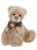 A plush, cream-coloured teddy bear sits upright, wearing a plaid and satin bow tie with fringe accents, featuring detailed paw pads, against a white background.