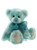 A teal and white fluffy teddy bear sits upright against a white background, wearing a sheer teal organza bow tied around its neck.