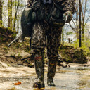 Lifestyle Image of the Lacrosse Burly Aero 17" Rubber Boots in Mossy Oak Original Bottomland.