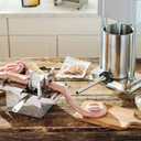 In use image of the LEM 8 oz. Vacuum Sealed Bag Hog Casings for 25 lbs. Meat.