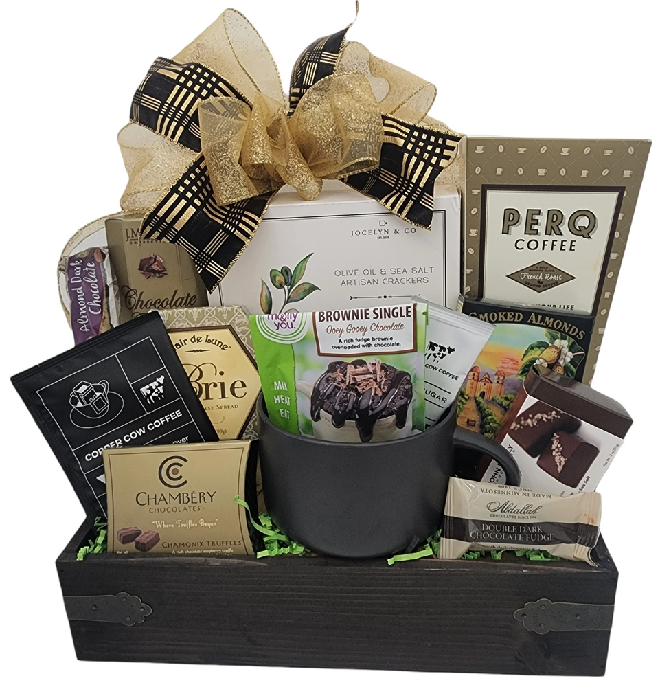 Designed in a wood tray with metal handles, and includes: An oversized cup, Vietnamese coffee, perq Coffee, Assorted milk and dark chocolates, Smoked Almonds, Biscotti, mug cake mix (add water and mix into mug and bake in microwave.