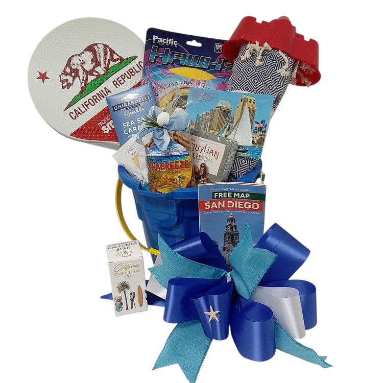 This fun gift basket is perfect for beach lovers of all ages! It is designed in a castle shaped beach bucket and includes:
A Beach Throw
Beach Paddleball Game
Frisbee
Sea Breeze Snack Mix
Sea Shell Shaped Belgian Chocolate
A Sea Salt Caramel Ghirardelli Bar
Beach Themed Box Of Gummy Bears
Shortbread from the Rustic Bakery
Bucket colors vary. A ribbon banner can be added with any text of your choice.