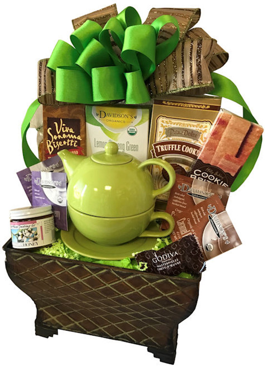 A beautiful metal planter filled with tea, biscotti, cookies, honey, and a tea for One teapot with cup and saucer.