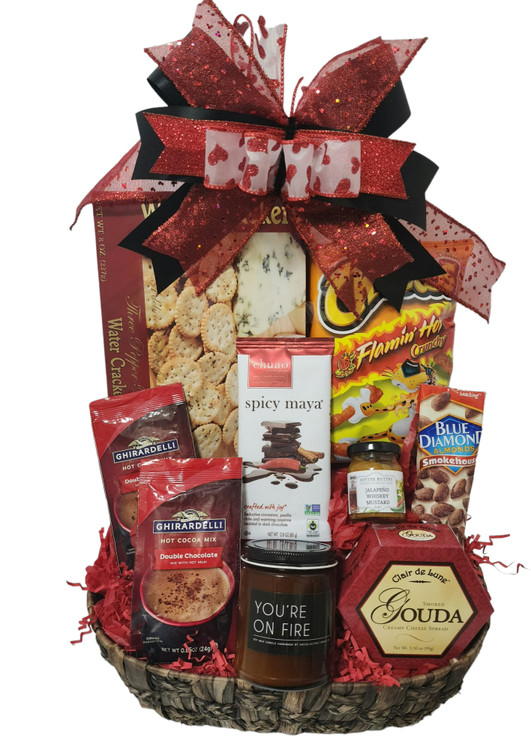 A  striking assortment of sweet, savory, and spicy goodies, along with a candle that says "Your On Fire!"                      