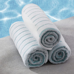 Colorfill Teal Stripe Pool Towels – 30" x 60", rolled and sitting at pool side