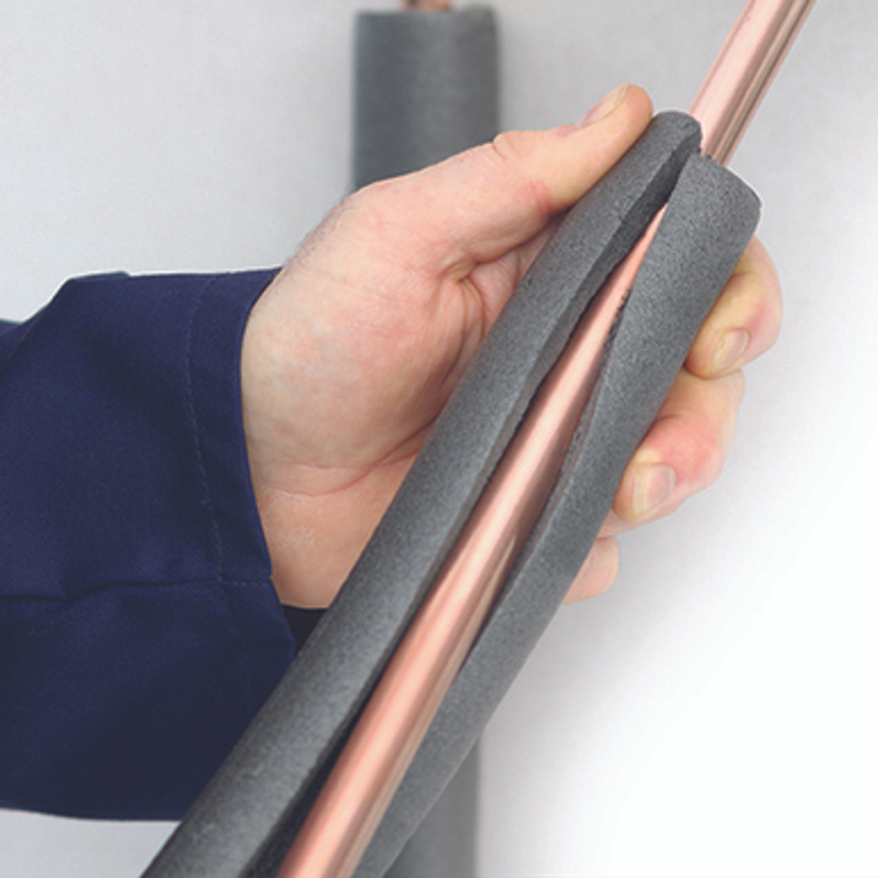 Installing pipe insulation onto copper pipe