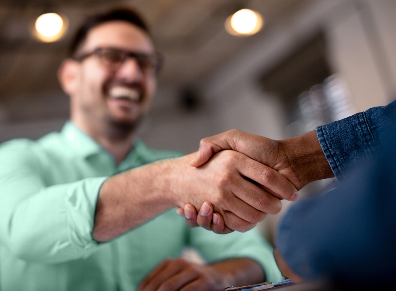 Man shaking another's hand