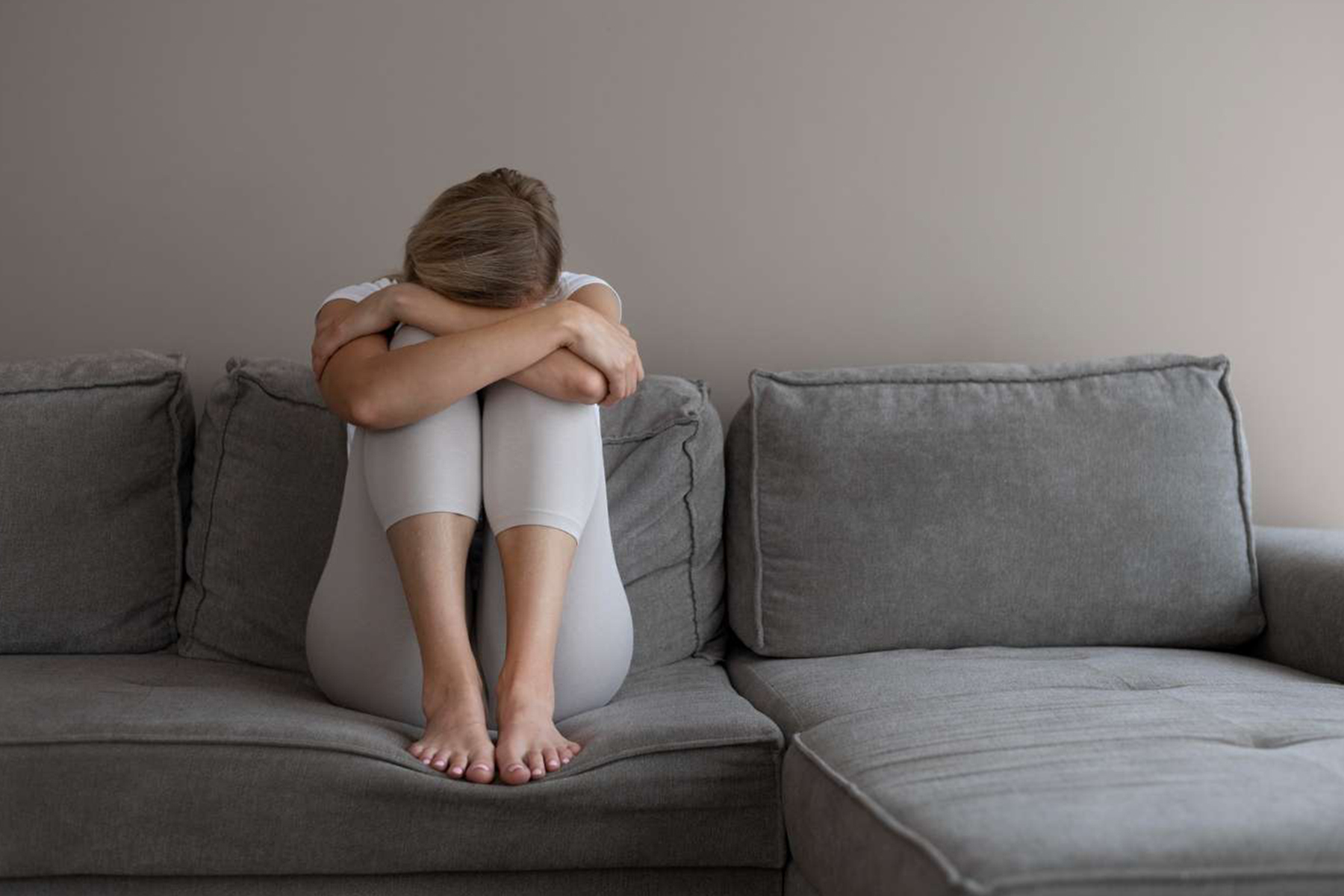 Depressed woman sitting on couch