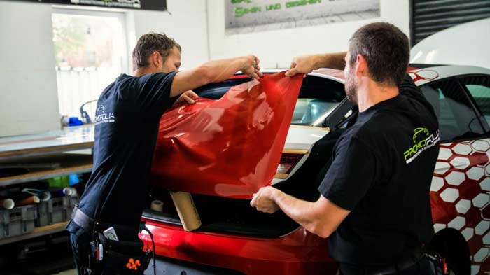 Promofolia installers applying a professional vehicle wrap