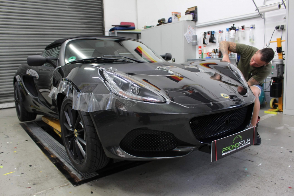 Professional installation of transparent paint protection film on a sports car