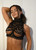Sensual black French lace high-collar bralette with Calais-Caudry floral detailing and sheer inserts, handmade in Europe
Description: Close-up of this luxurious black halter bralette showcasing hand-selected intricate floral French lace from the historic factories of Calais and Caudry in northern France. The mock-neck collar and scalloped lace overlay dramatic sheer tulle mesh panels and open sweetheart cups, finished with precise scalloped borders and ribbon accents for timeless romance. All elements are handmade in Europe with components produced entirely in Europe.
