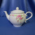 A Pink Floral Basket Weave Teapot by Teleflora Inc.