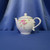 A Pink Floral Basket Weave Teapot by Teleflora Inc.