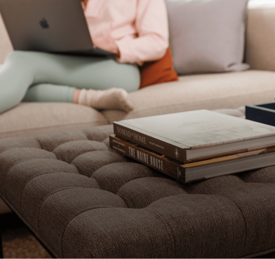 Person reading on Wovenbyrd Ottoman