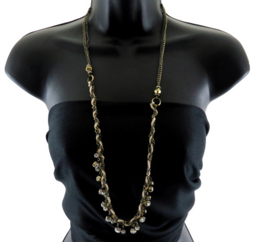 Long necklace with two chains on the top half and on the bottom half string is added and braided with the two chains and rhinestone charms linked to the braid QN120