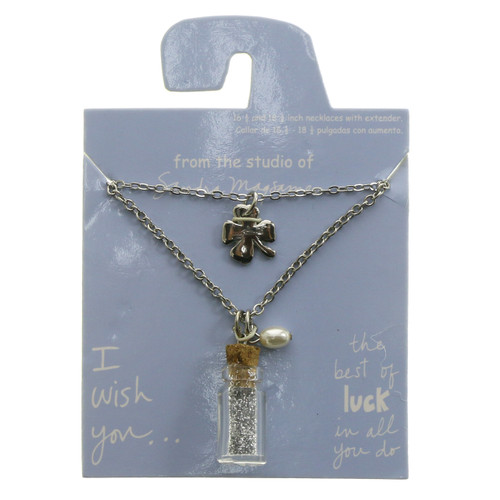 Set of two necklaces both have extenders, one with a shamrock charm and the other with a charm of a plastic bottle with glitter inside ppn658