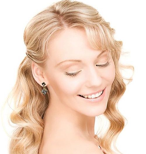 Gold tone cubic zirconia dangle earrings with a diamond shaped stone hanging from a diamond shaped post CZ28